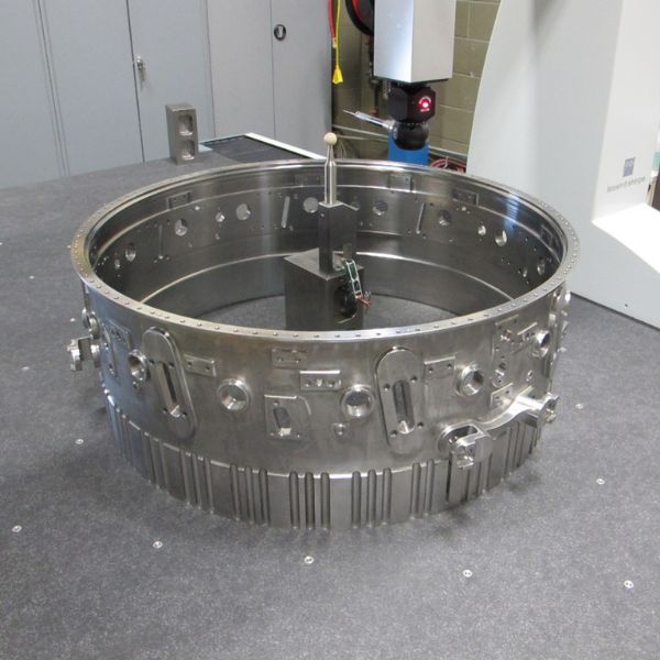 A coordinate measuring machine (CMM) probe inspecting the dimensional accuracy of a large turbine casing.