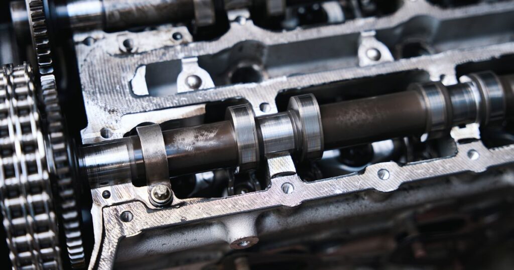 Automotive camshaft machining process with grinding, heat treatment, and inspection stages