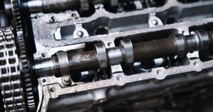 Automotive camshaft machining process with grinding, heat treatment, and inspection stages