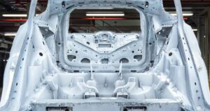 Solutions 7 CNC machining of die-cast parts: a large gigacast aluminum EV body casting machined to tolerance