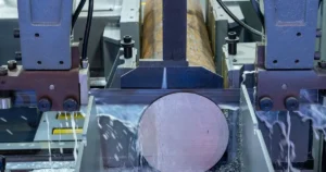 CNC metal band saw machine cutting large steel stock in an industrial workshop